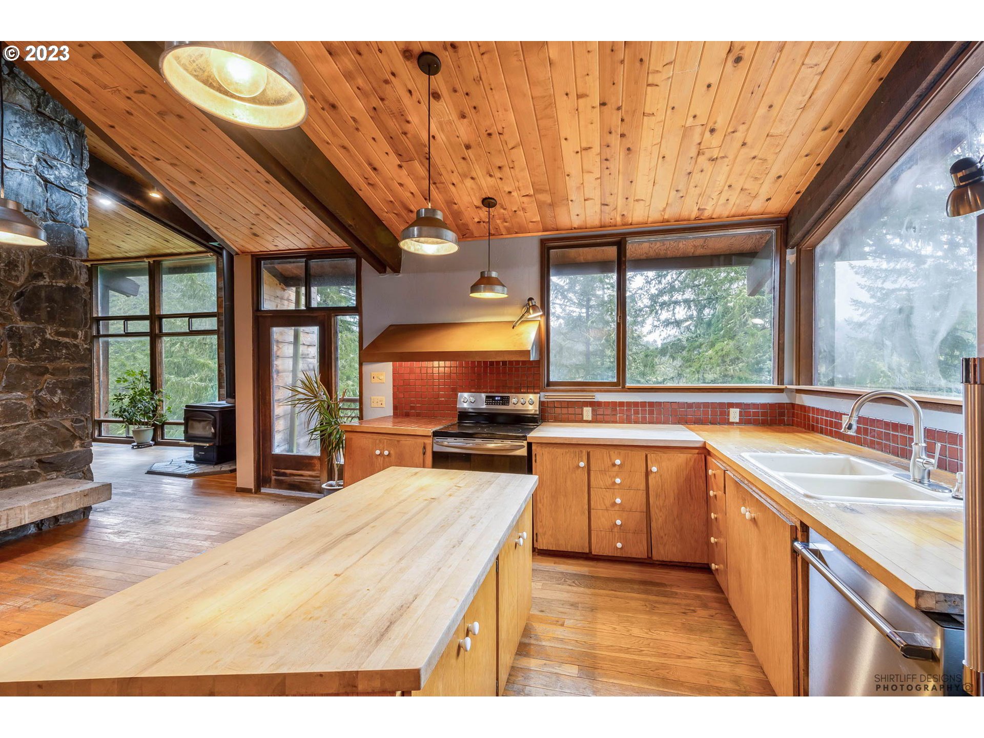 27313 Briggs Hill Road Eugene, OR 97405 - Photo 13 of 48 a kitchen with stainless steel appliances granite countertop a stove a sink and a microwave