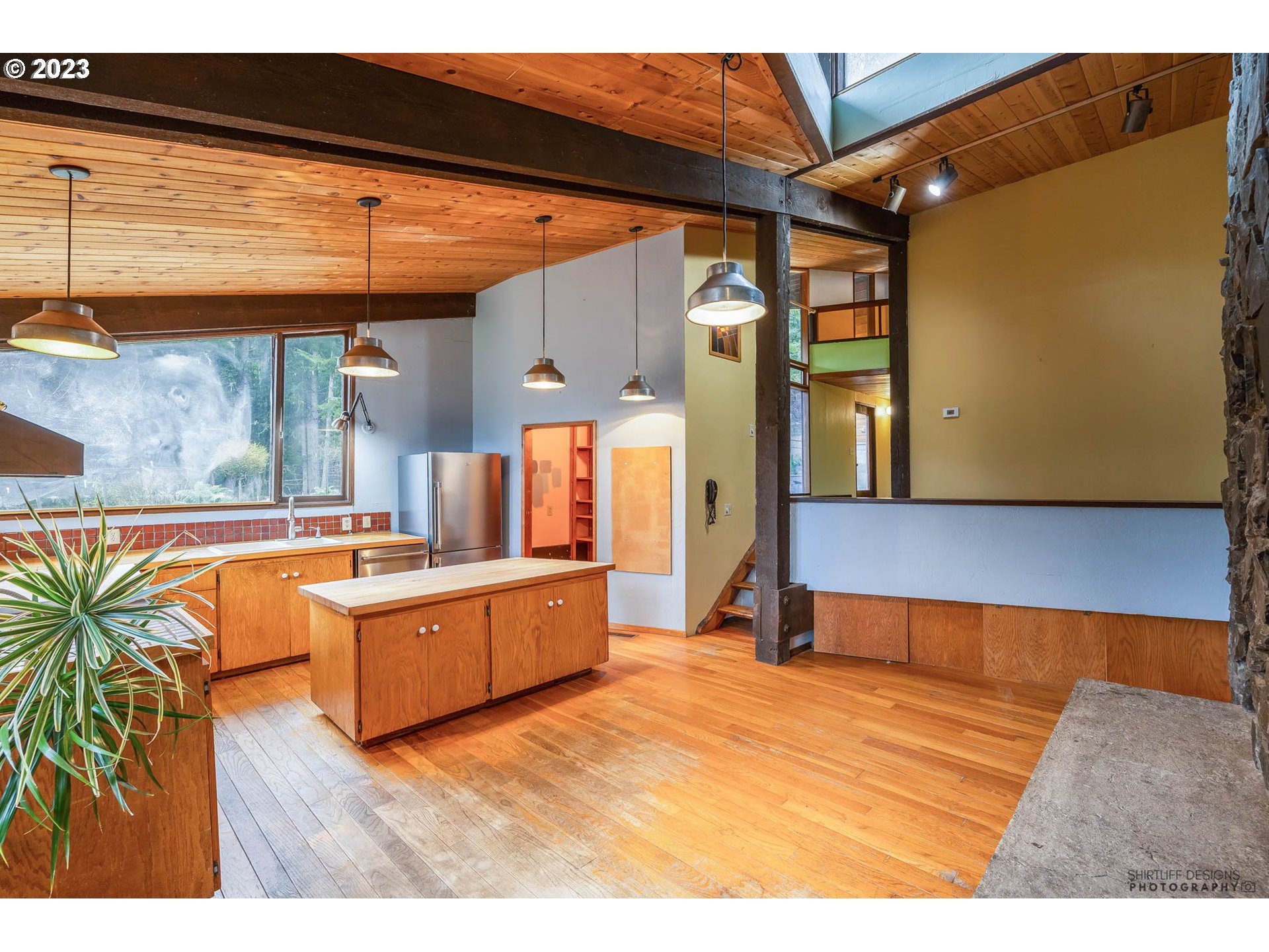 27313 Briggs Hill Road Eugene, OR 97405 - Photo 17 of 48 a kitchen with stainless steel appliances kitchen island granite countertop a sink and a black umbrella