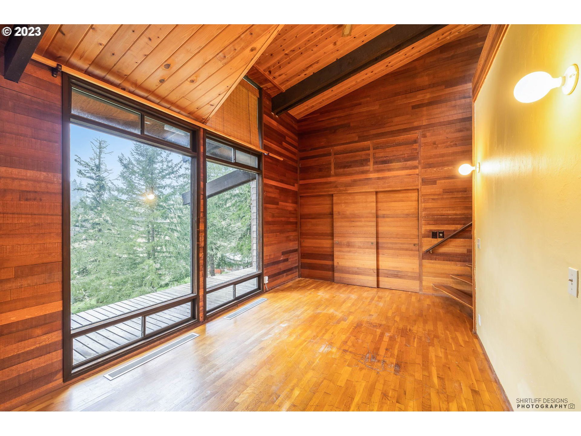 27313 Briggs Hill Road Eugene, OR 97405 - Photo 22 of 48 a view of a room with wooden floor and windows