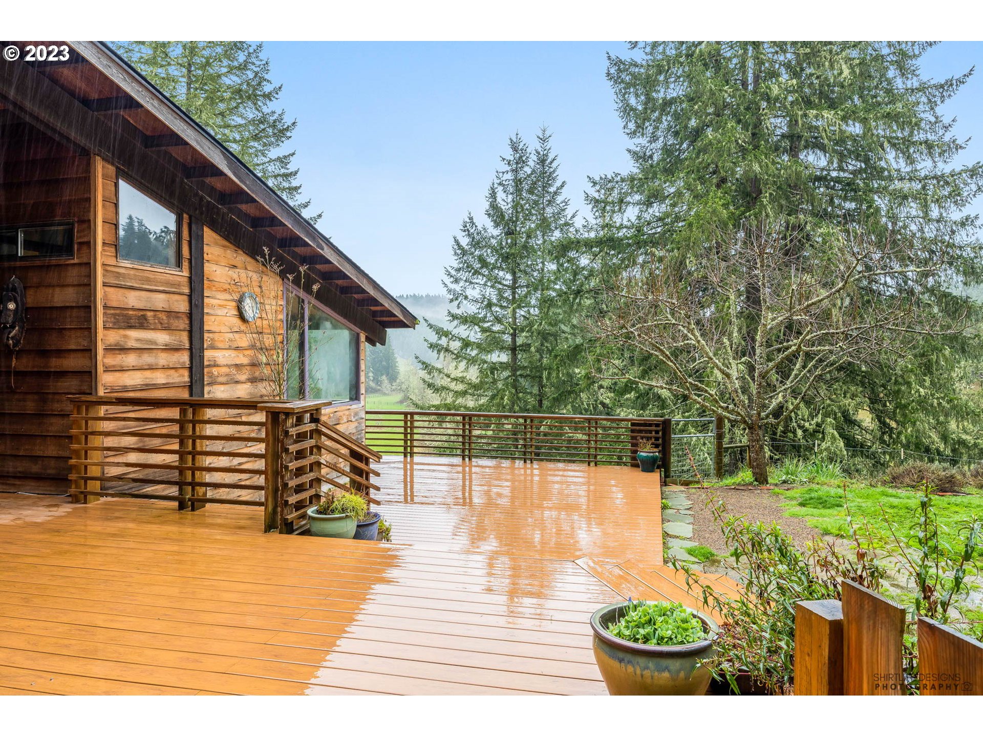 27313 Briggs Hill Road Eugene, OR 97405 - Photo 39 of 48 a view of a backyard with plants and lake view