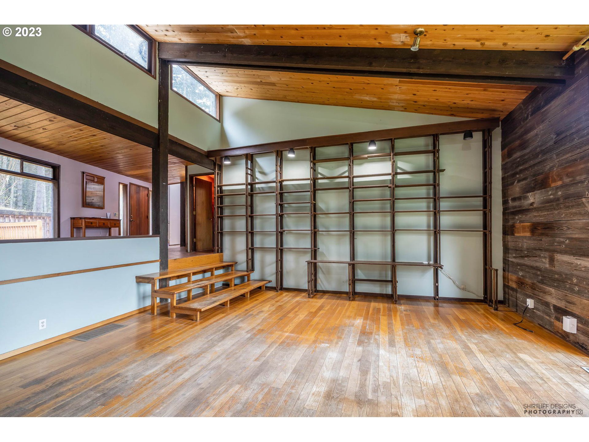 27313 Briggs Hill Road Eugene, OR 97405 - Photo 8 of 48 a view of an empty room with wooden floor and a window