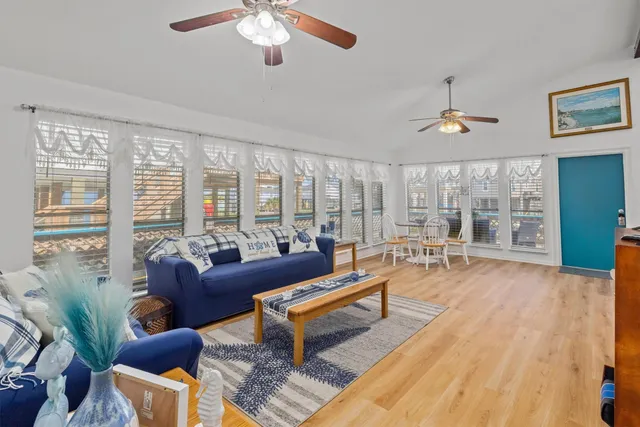 a dining room with furniture a chandelier and wooden floor