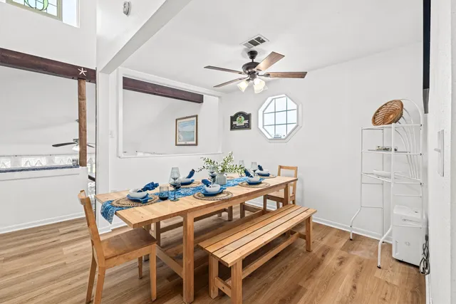 a dining room with furniture a potted plant and a chandelier