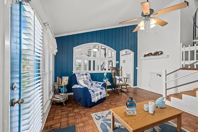 a living room with furniture and stairs