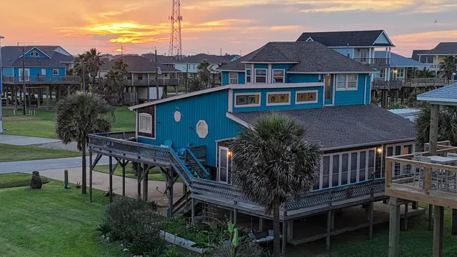 a aerial view of a house with a yard table and chairs