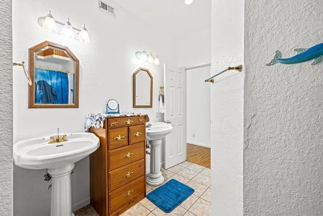 a bathroom that has a sink mirror and toilet