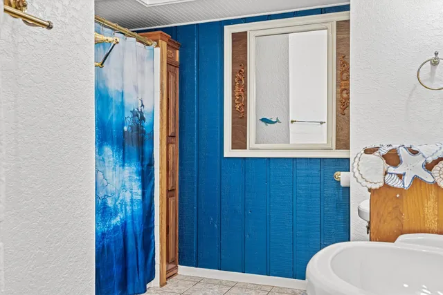 a balcony with chairs and wooden floor