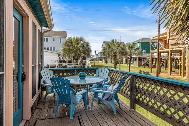 a view of a balcony with wooden floor and outdoor seating