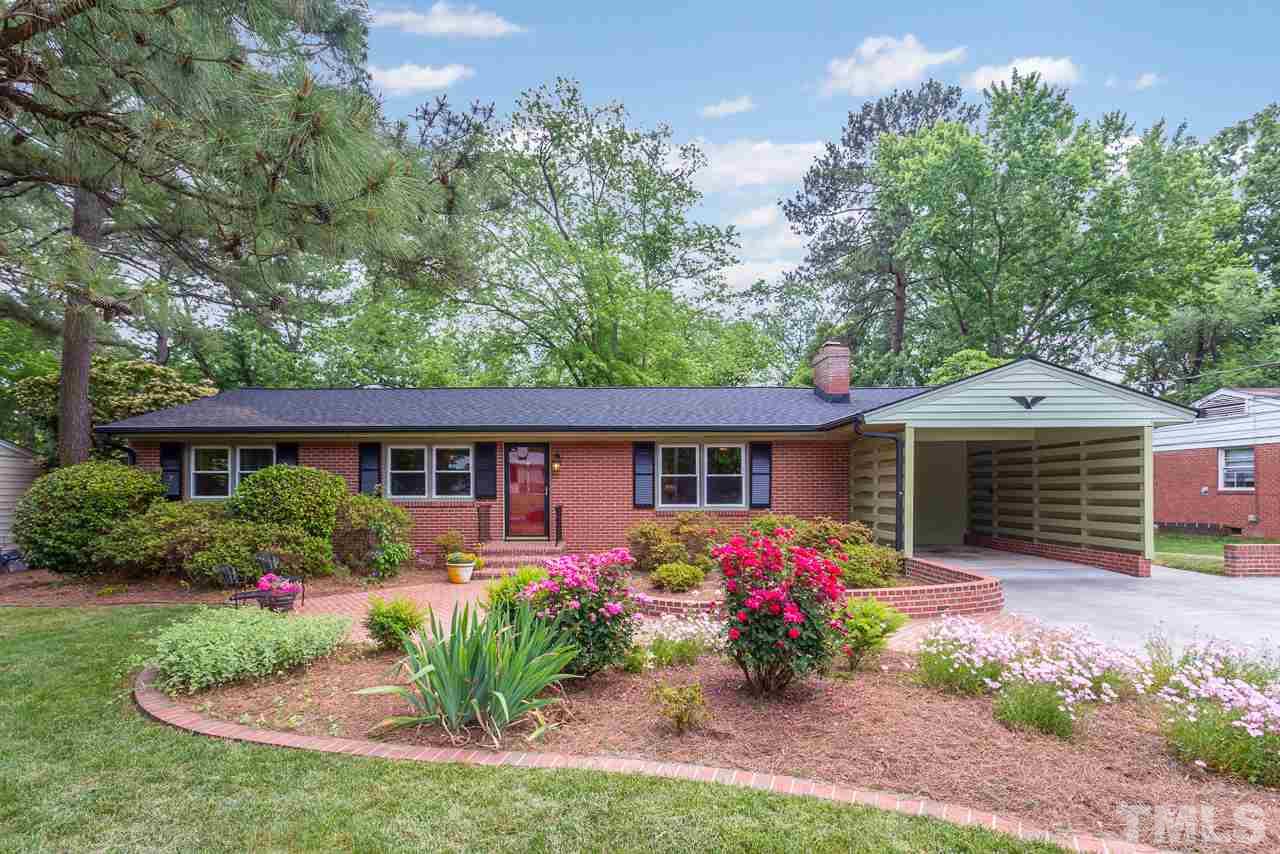 5113 Wickham Road Raleigh, NC 27606 - Photo 1 of 25 a front view of a house with yard and a garden