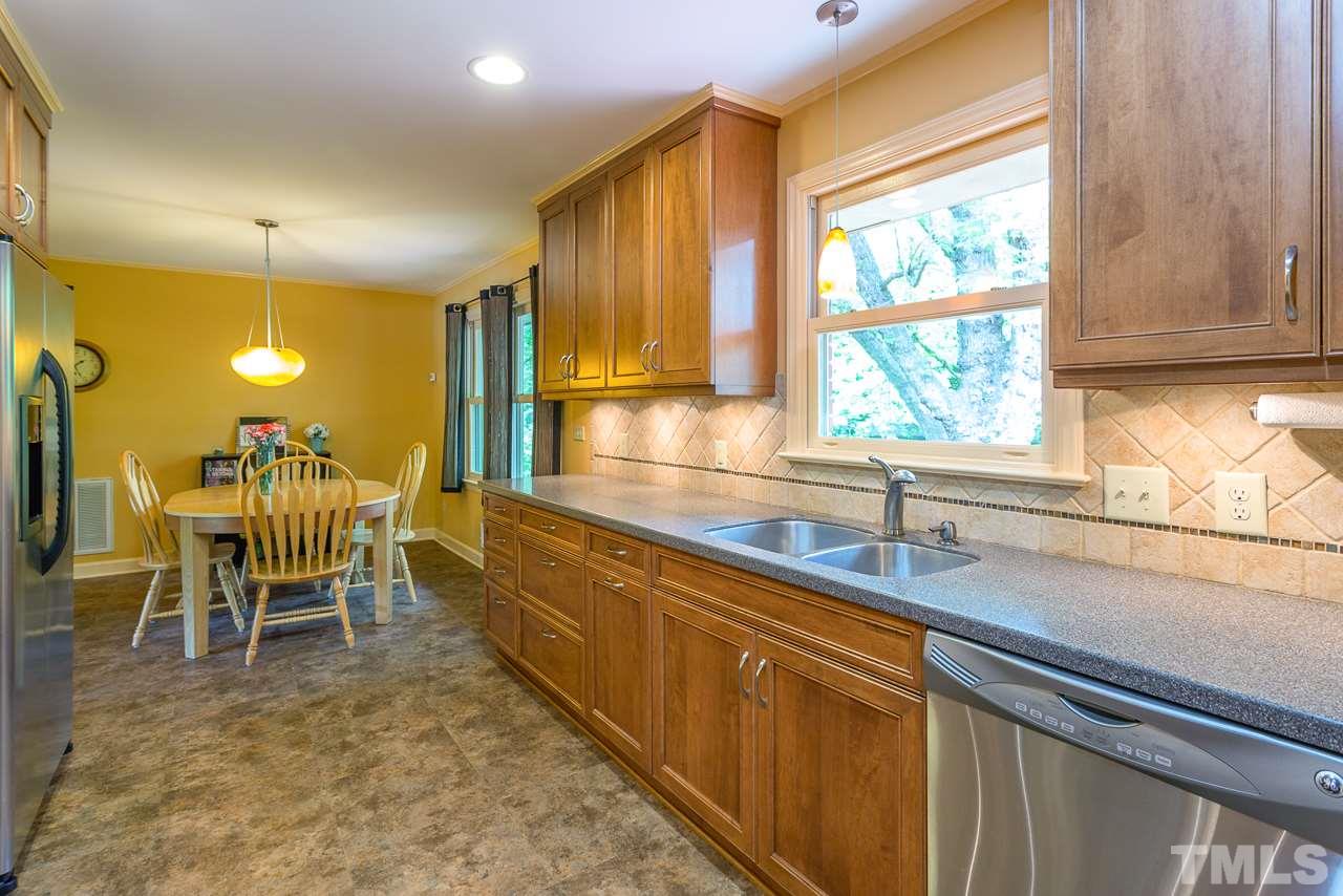 5113 Wickham Road Raleigh, NC 27606 - Photo 11 of 25 a kitchen with a sink and chairs