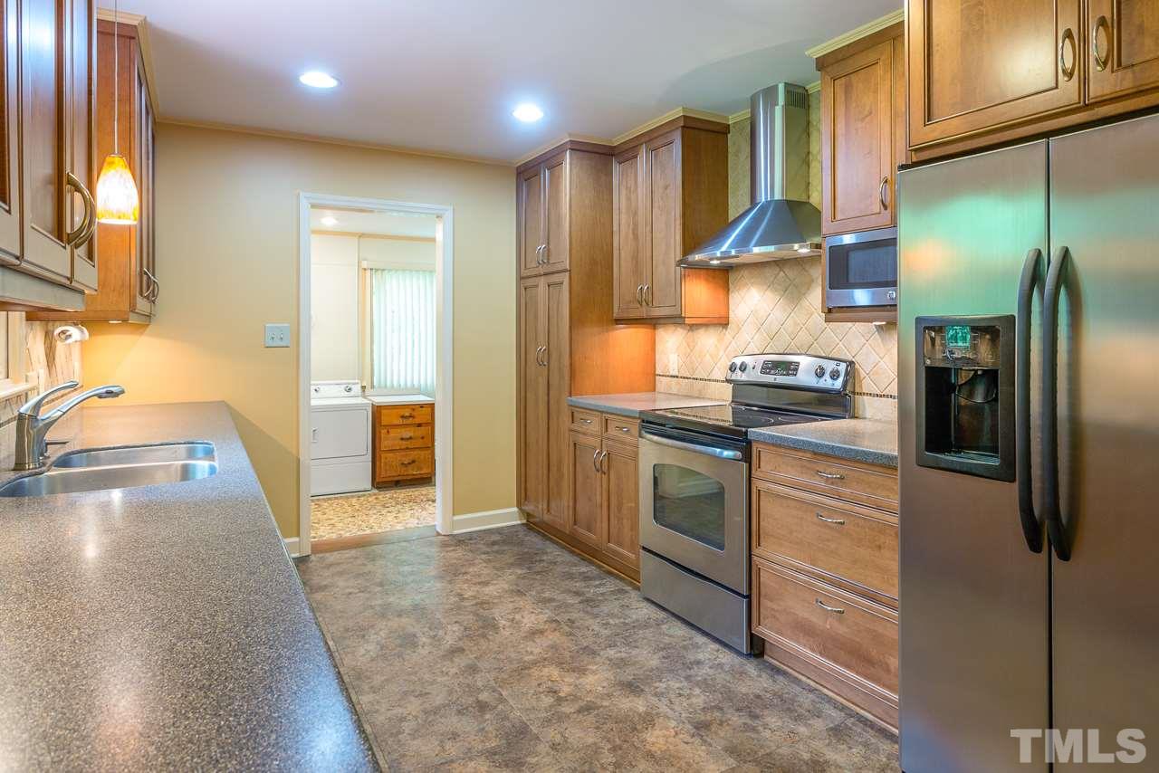 5113 Wickham Road Raleigh, NC 27606 - Photo 12 of 25 a kitchen with stainless steel appliances granite countertop a refrigerator and a sink
