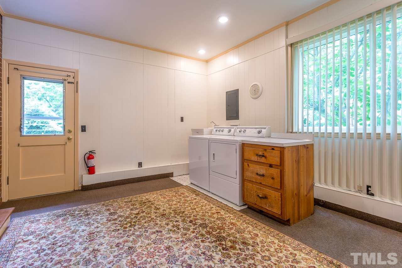 5113 Wickham Road Raleigh, NC 27606 - Photo 14 of 25 a room with a dresser and a window