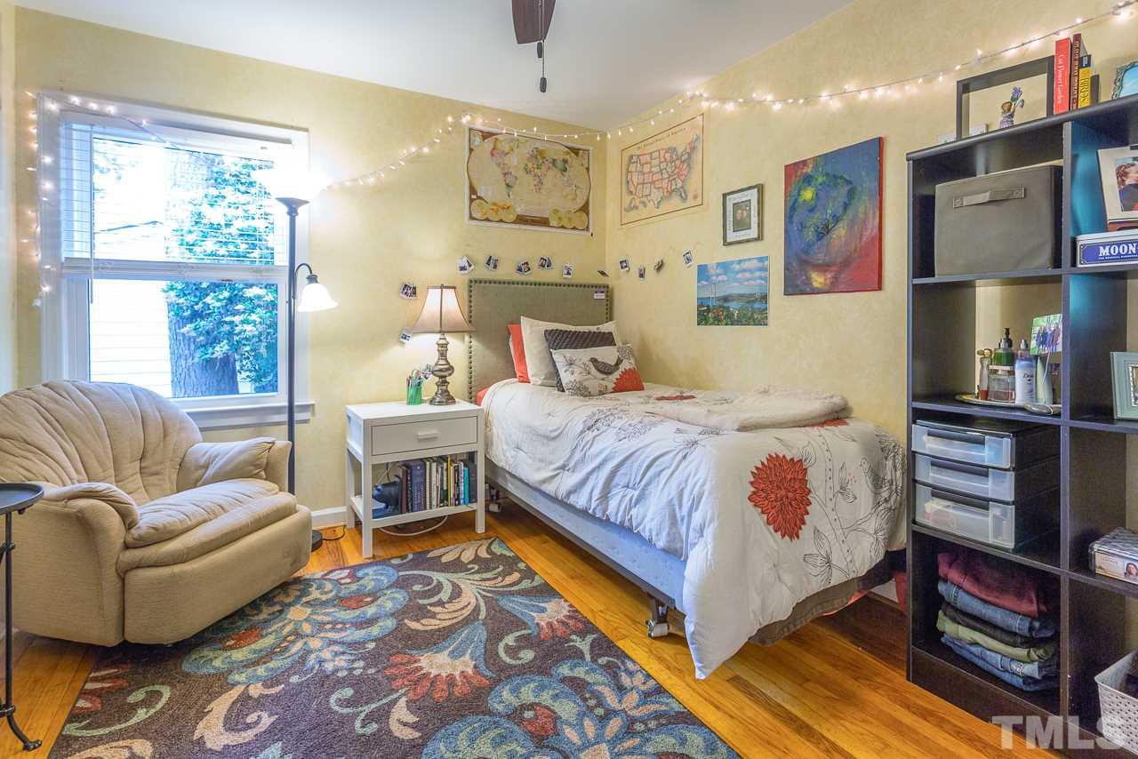 5113 Wickham Road Raleigh, NC 27606 - Photo 15 of 25 a bedroom with a bed couch and a window