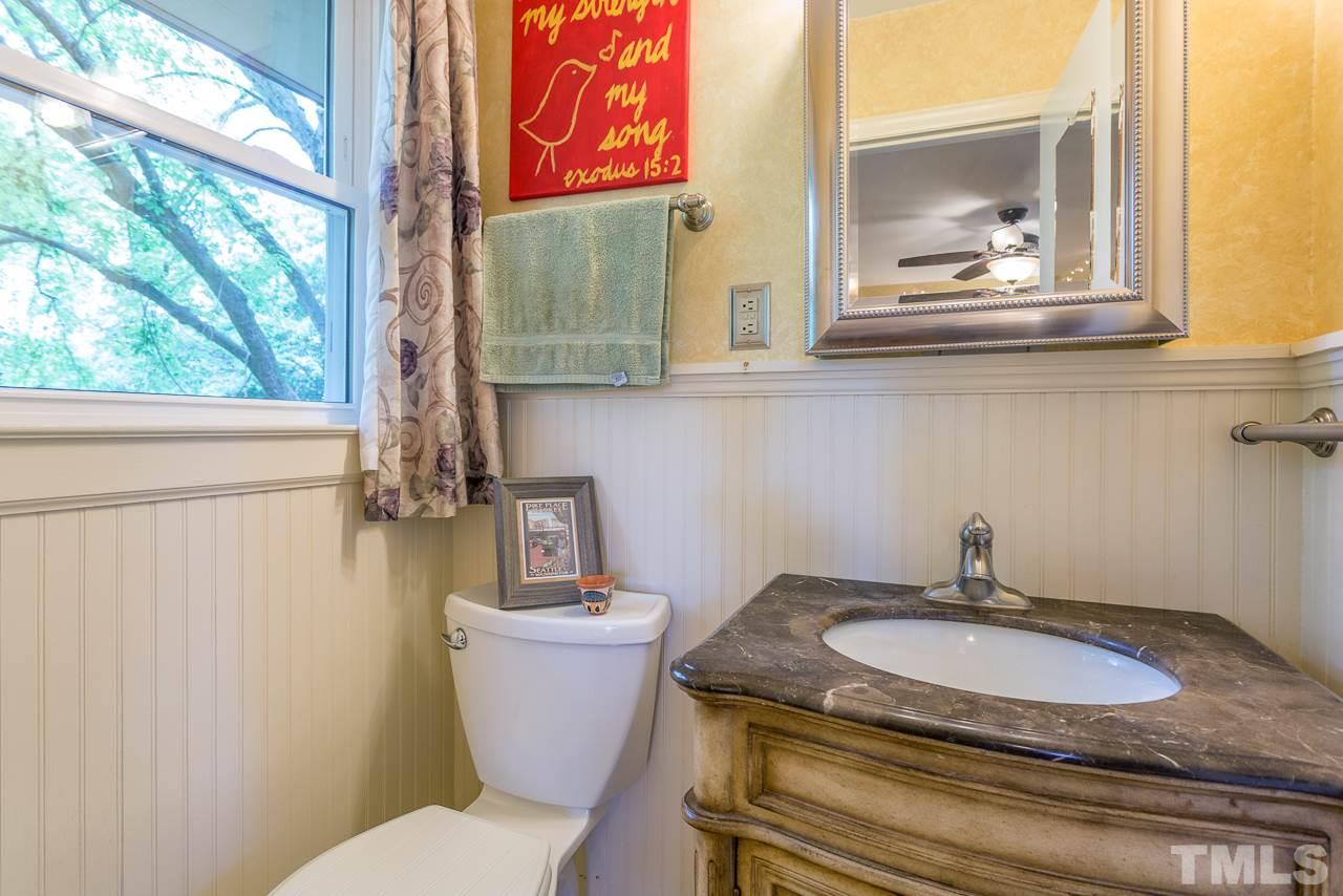 5113 Wickham Road Raleigh, NC 27606 - Photo 16 of 25 a bathroom with a granite countertop sink and a mirror