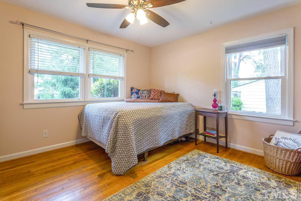 5113 Wickham Road Raleigh, NC 27606 - Photo 17 of 25 a bedroom with a bed and a window