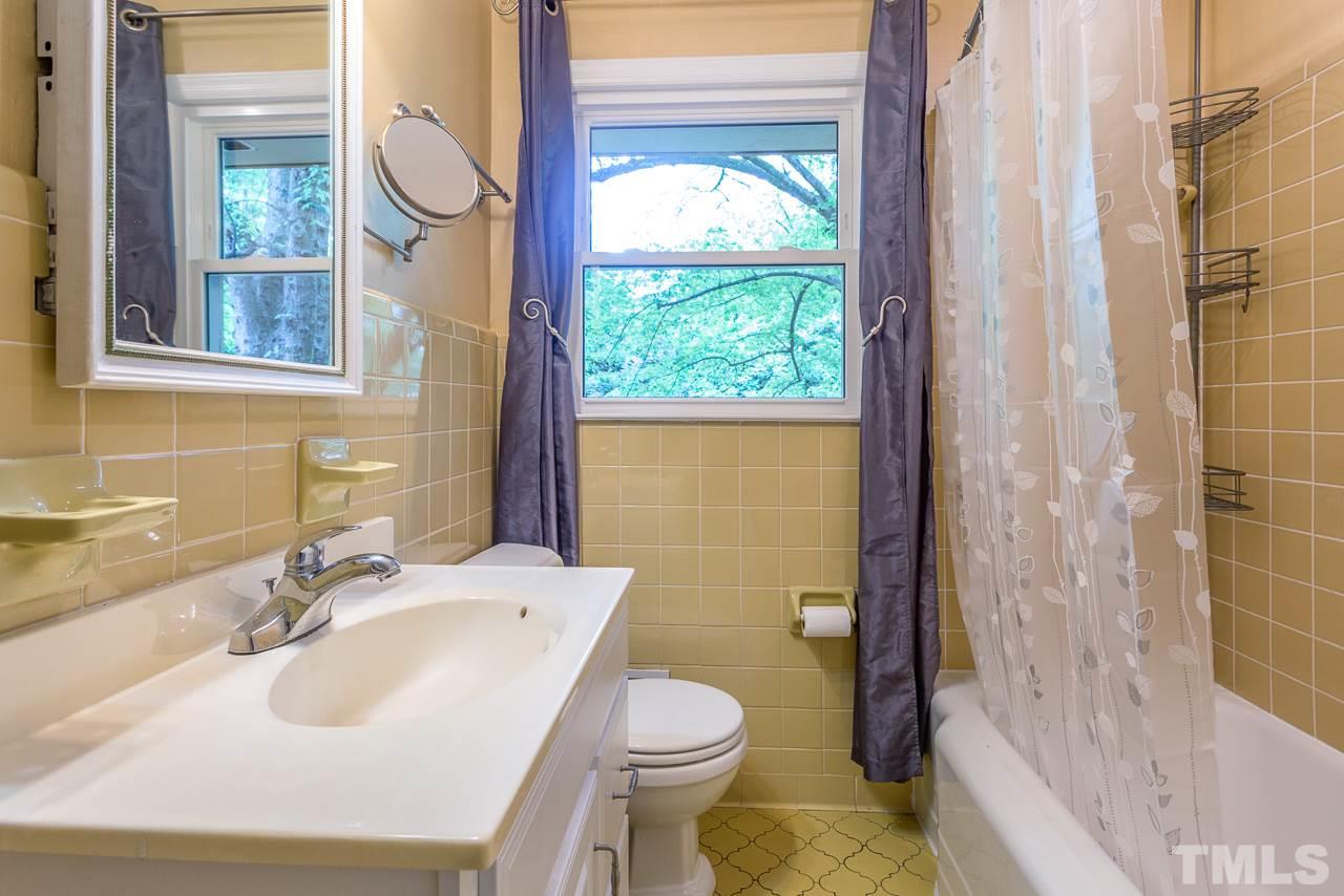 5113 Wickham Road Raleigh, NC 27606 - Photo 18 of 25 a bathroom with a sink a toilet and shower