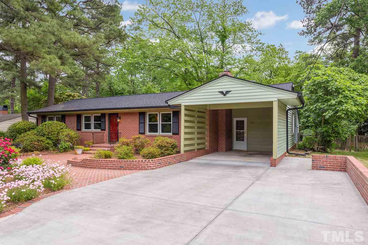 5113 Wickham Road Raleigh, NC 27606 - Photo 3 of 25 a front view of a house with a garden and porch