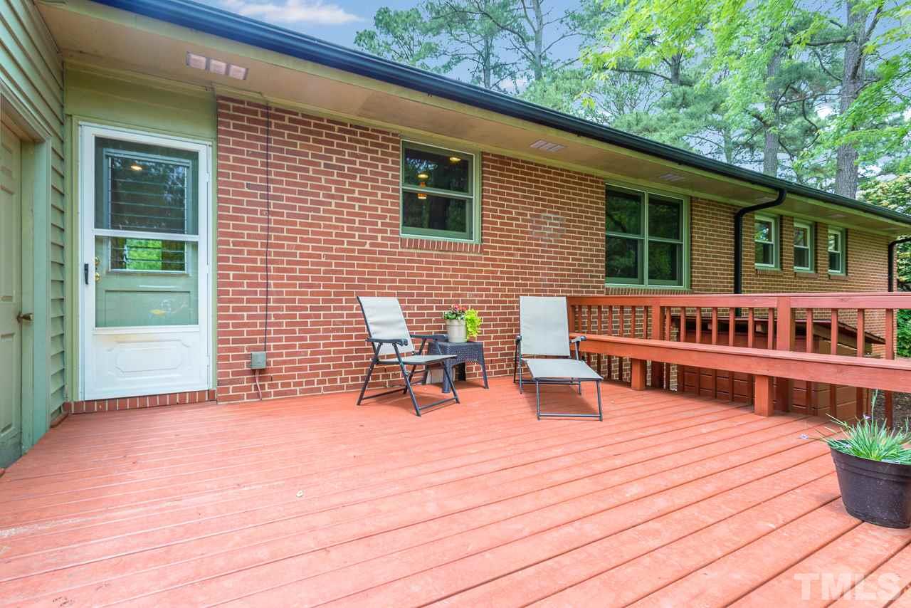 5113 Wickham Road Raleigh, NC 27606 - Photo 21 of 25 a view of a patio with a table and chairs