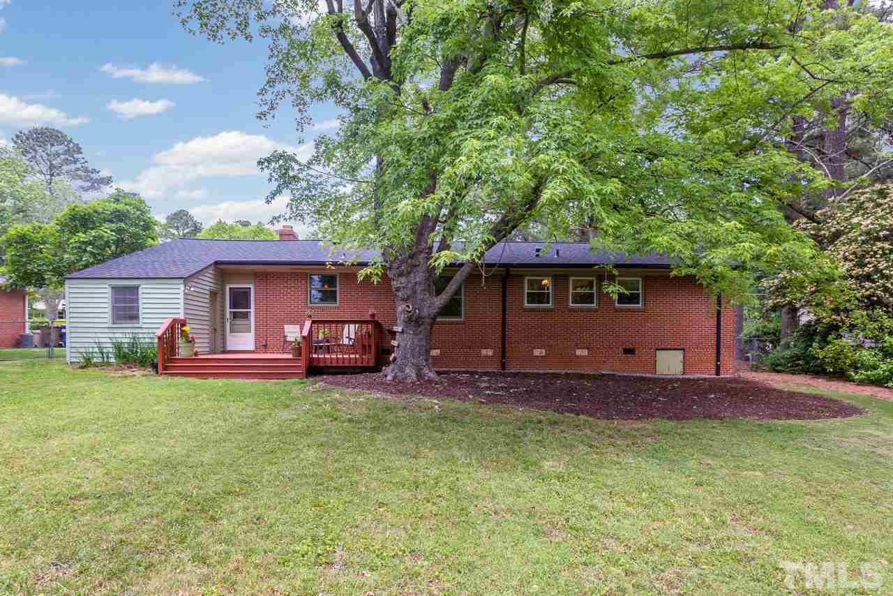 5113 Wickham Road Raleigh, NC 27606 - Photo 22 of 25 a front view of a house with a garden and trees