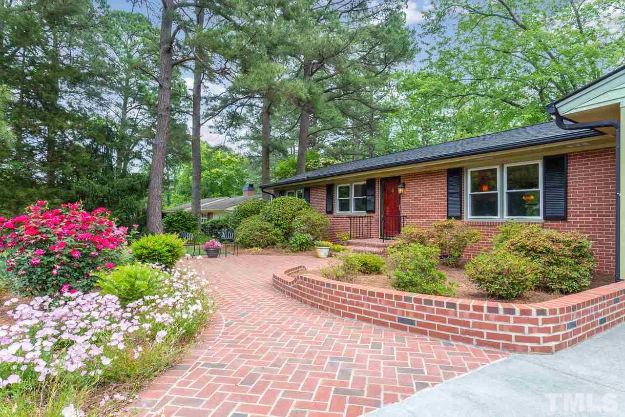 5113 Wickham Road Raleigh, NC 27606 - Photo 4 of 25 a front view of a house with a yard and potted plants