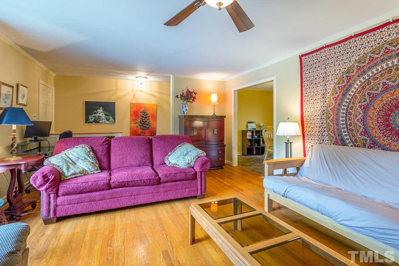 5113 Wickham Road Raleigh, NC 27606 - Photo 7 of 25 a living room with furniture and a flat screen tv