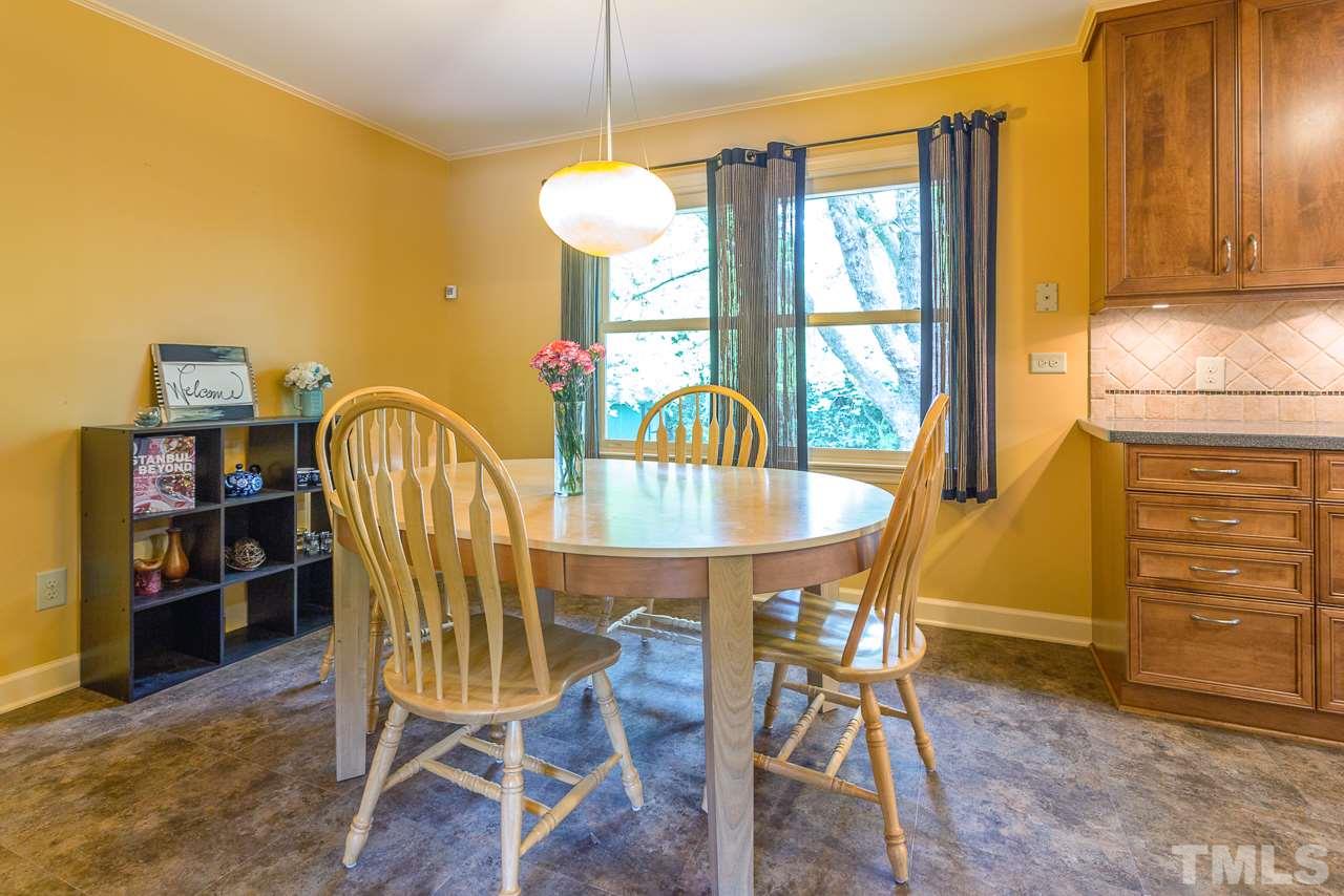 5113 Wickham Road Raleigh, NC 27606 - Photo 9 of 25 a view of a dining room with furniture and window
