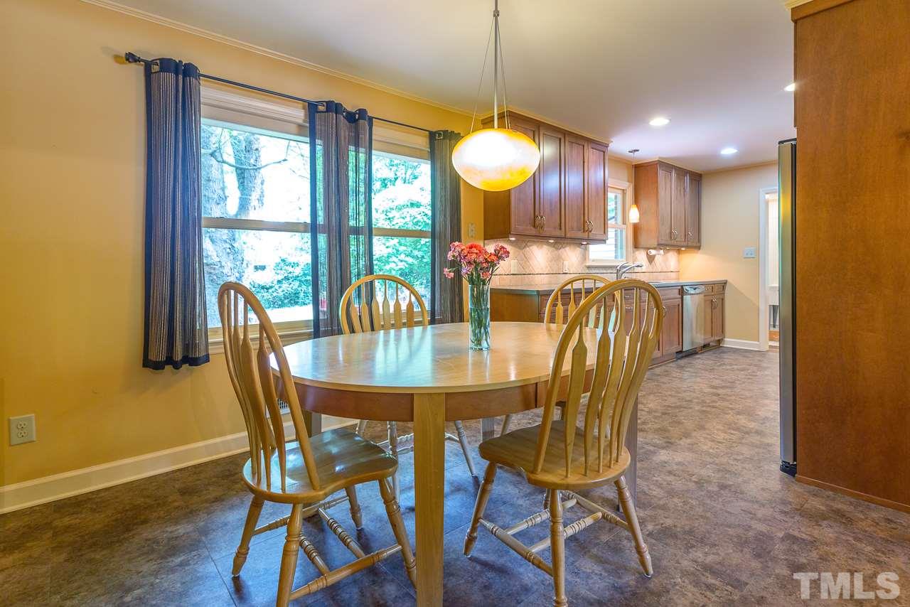 5113 Wickham Road Raleigh, NC 27606 - Photo 10 of 25 a view of a dining room with furniture window and wooden floor