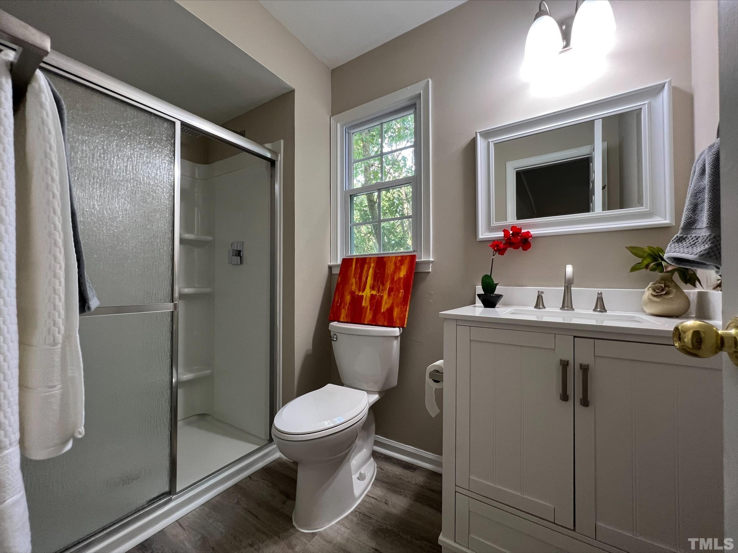 605 Sawmill Road Raleigh, NC 27615 - Photo 12 of 26 a bathroom with a toilet sink and shower