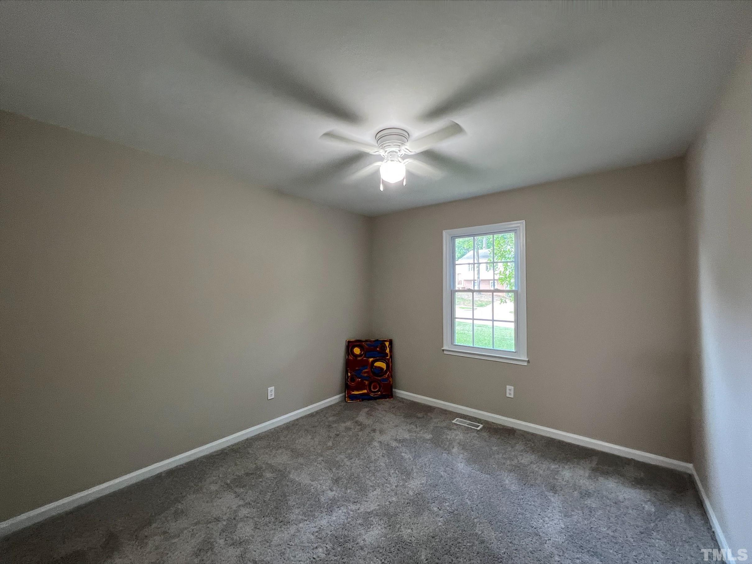 605 Sawmill Road Raleigh, NC 27615 - Photo 14 of 26 an empty room with windows and fan