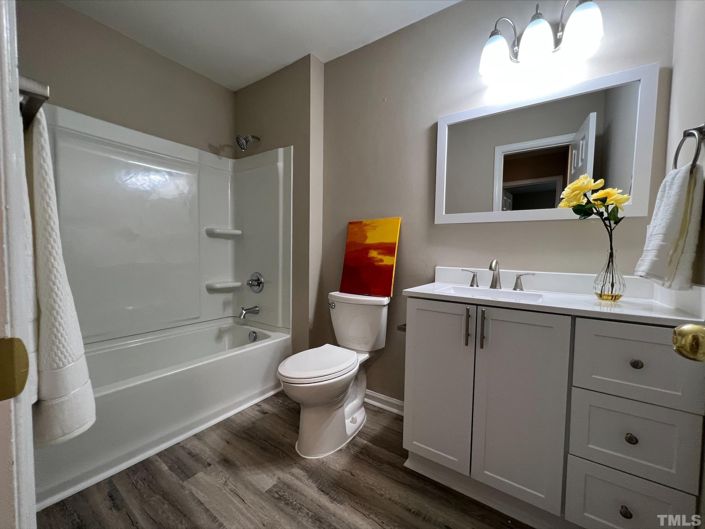 605 Sawmill Road Raleigh, NC 27615 - Photo 17 of 26 a bathroom with a sink toilet a mirror and shower