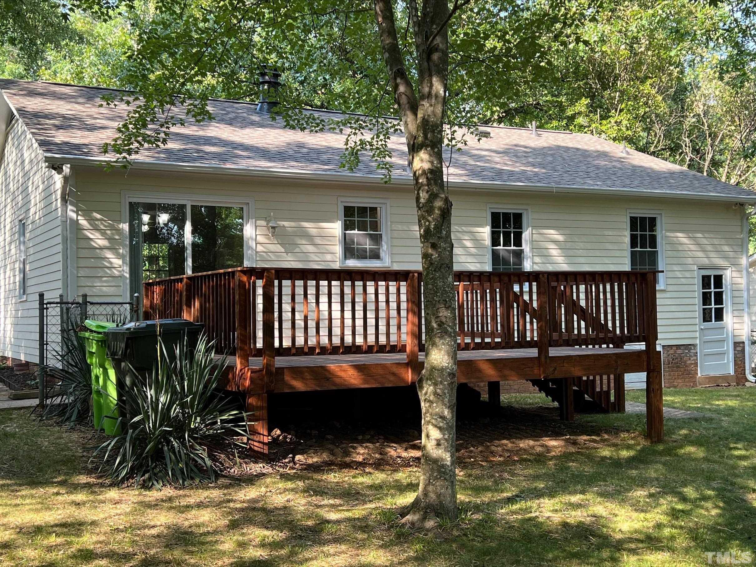 605 Sawmill Road Raleigh, NC 27615 - Photo 5 of 26 a view of a house with wooden deck and a swimming pool