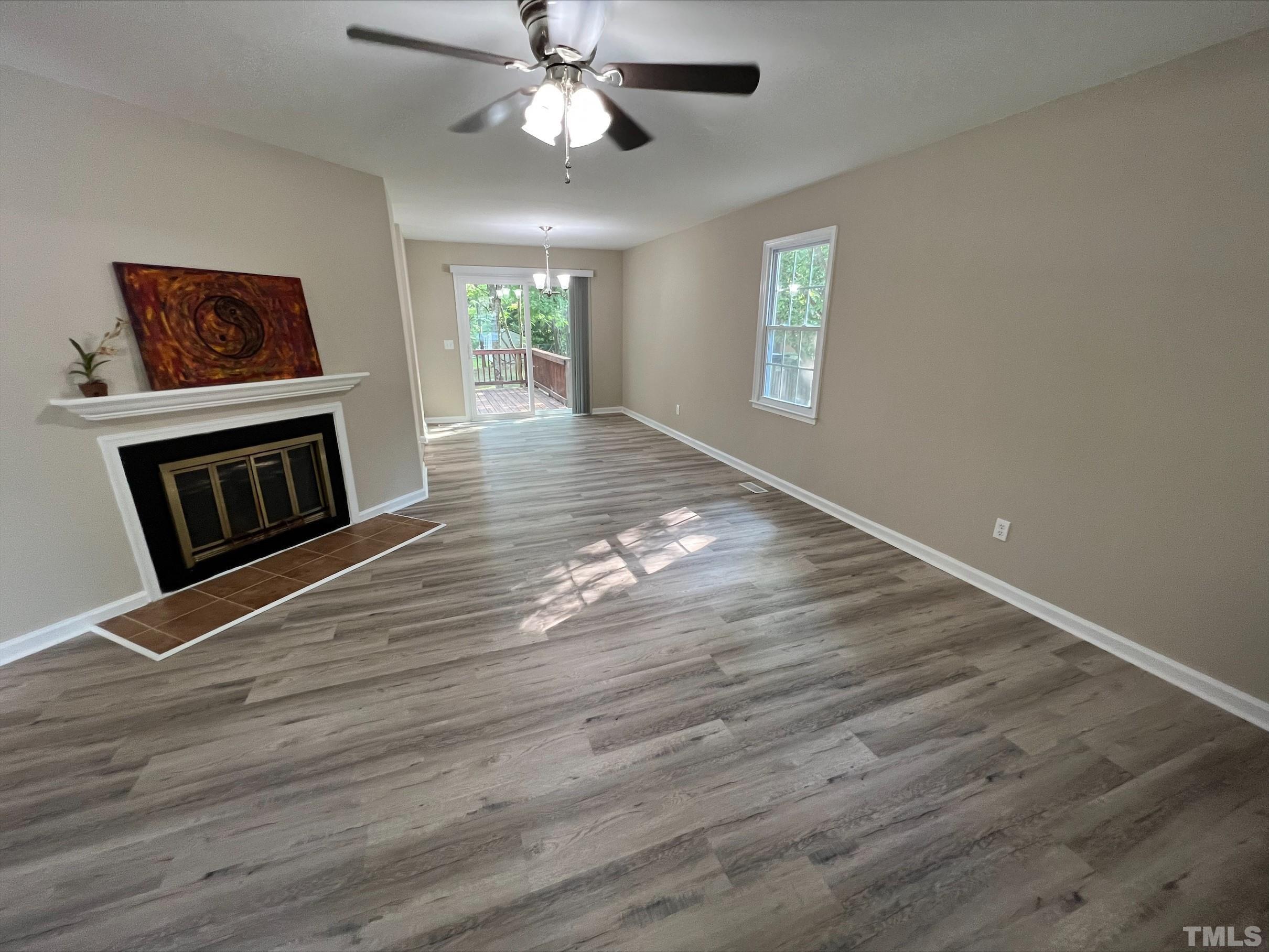 605 Sawmill Road Raleigh, NC 27615 - Photo 7 of 26 a view of an empty room with wooden floor and a window