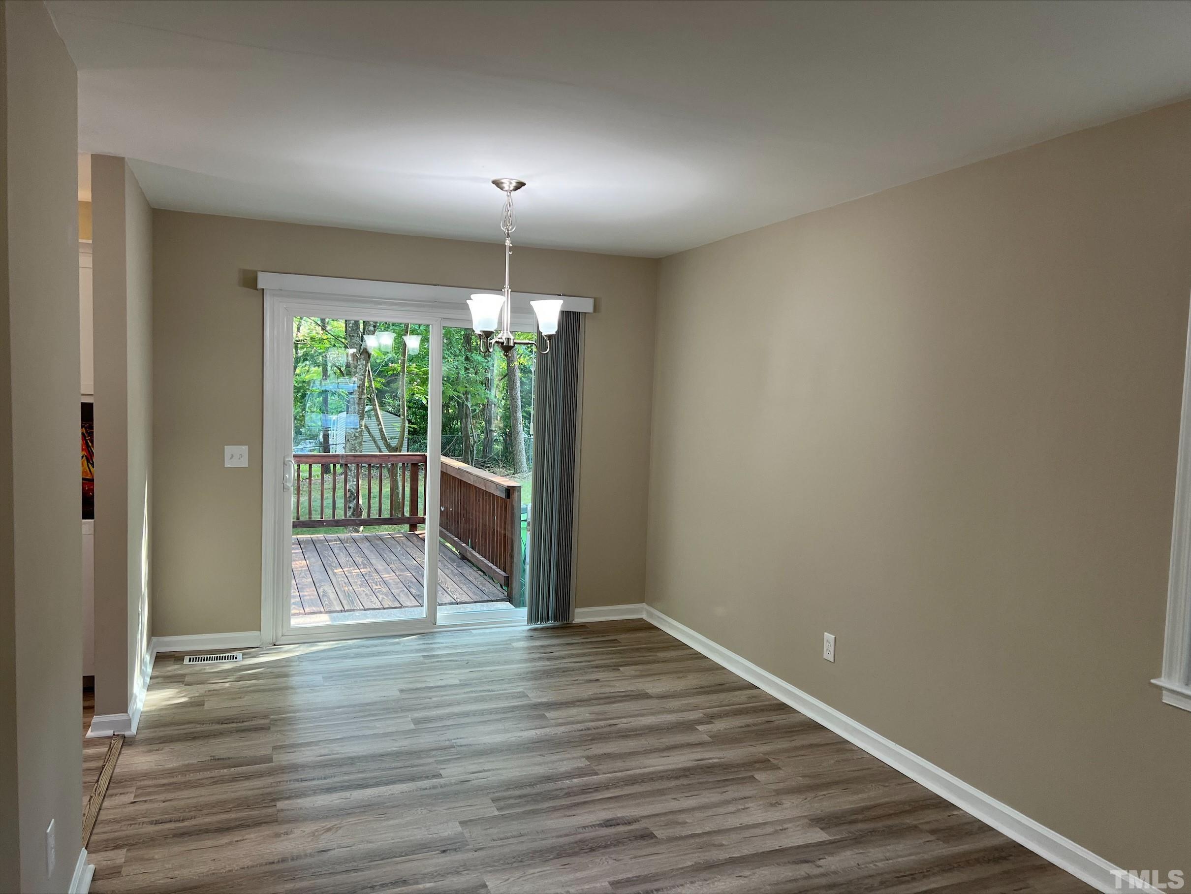 605 Sawmill Road Raleigh, NC 27615 - Photo 8 of 26 a view of empty room with wooden floor and fan