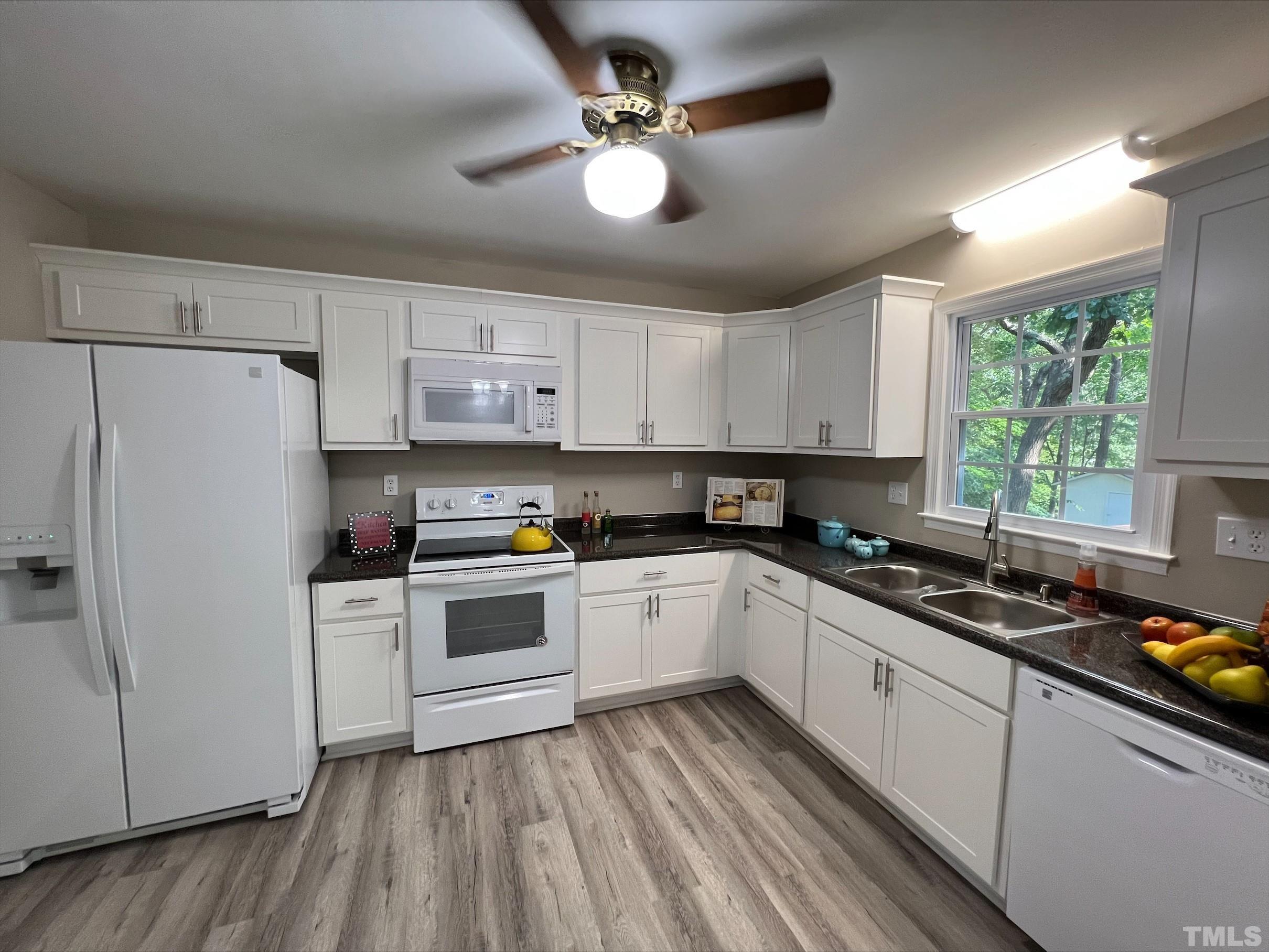 605 Sawmill Road Raleigh, NC 27615 - Photo 10 of 26 a kitchen with a white cabinets and white appliances