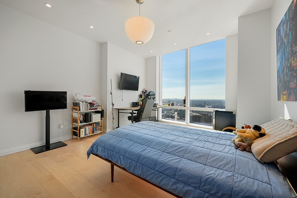 1 Franklin Street, Unit 4802 Boston, MA 02110 - Photo 22 of 42 a bedroom with a bed and a flat screen tv