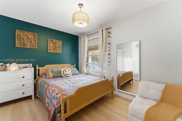 a bedroom with a bed and a chandelier