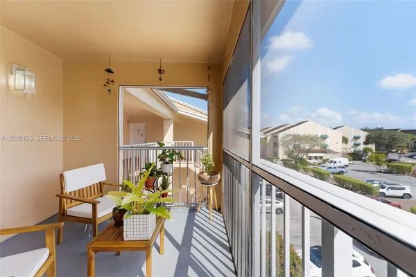 a view of a city from a balcony with furniture