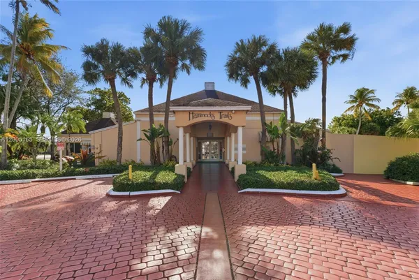 a view of a house with palm trees