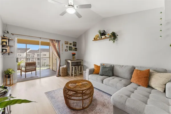 a living room with furniture and a floor to ceiling window