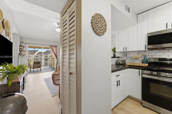 a kitchen with a sink a stove and cabinets
