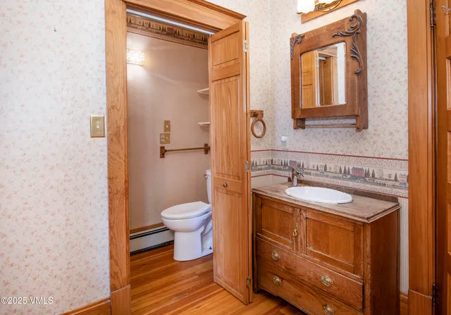 an aerial view of a house with a garden and lake view