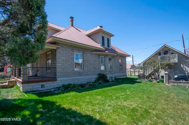 a view of a livingroom with wooden floor and a fireplace