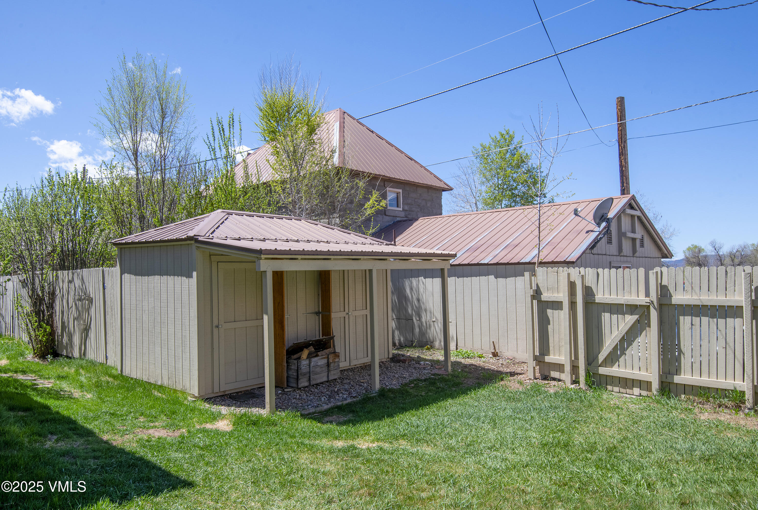 409 Washington Street Eagle, CO 81631 - Photo 21 of 28 a view of a house with a yard potted plants and a bench
