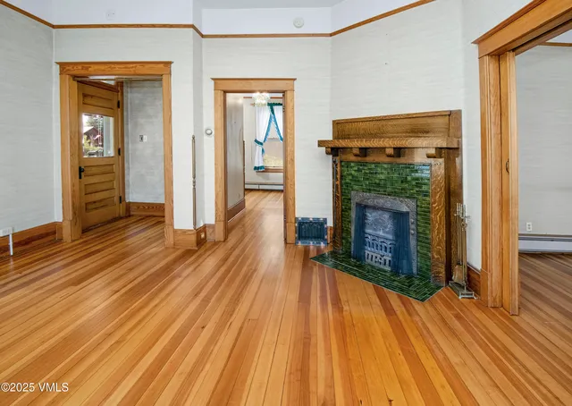 a view of a livingroom with a hall and a ceiling fan