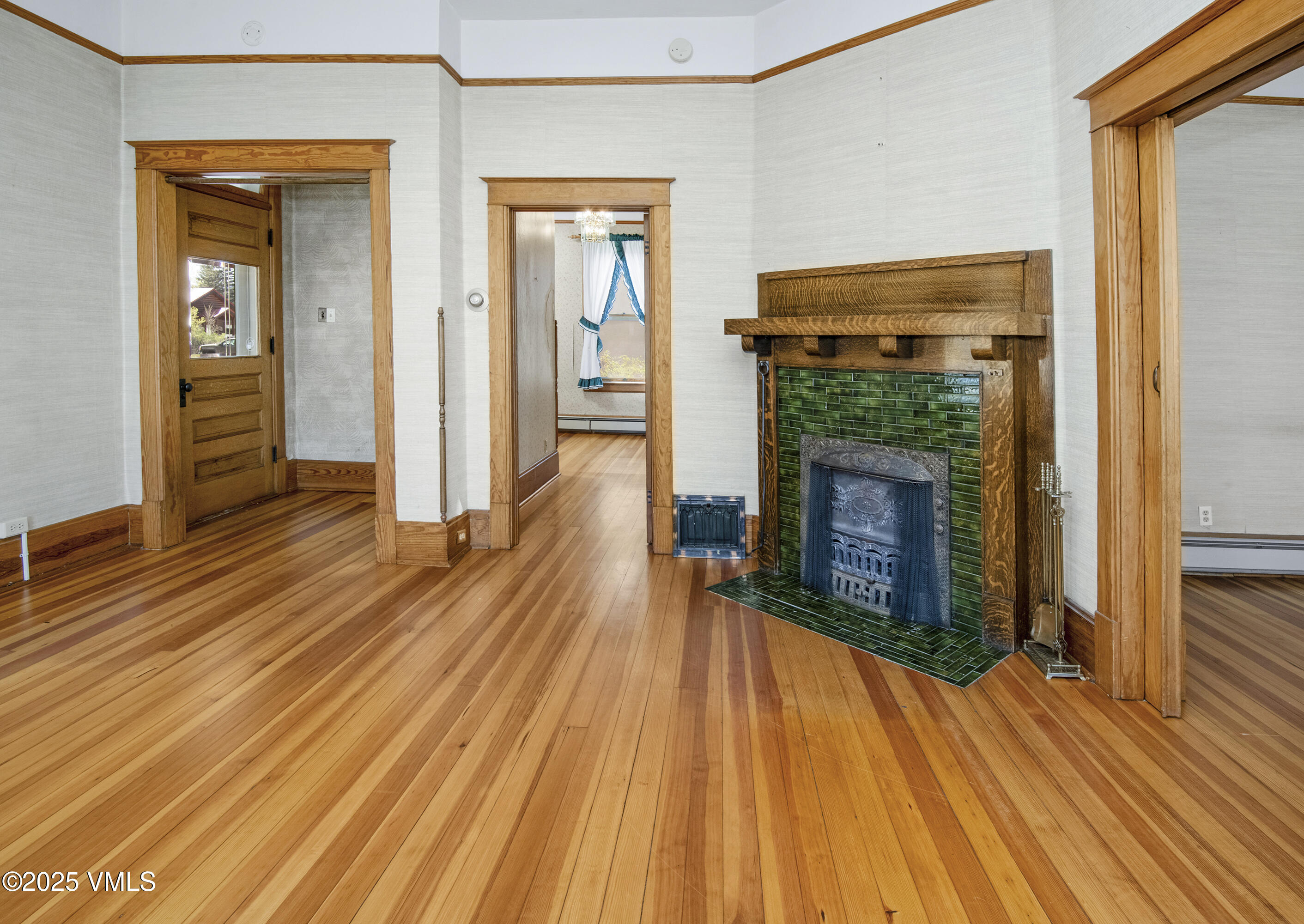 409 Washington Street Eagle, CO 81631 - Photo 6 of 28 a view of a livingroom with wooden floor and a fireplace