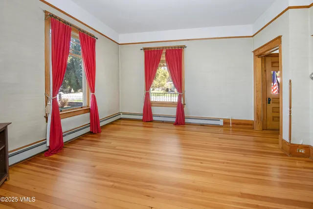 an empty room with windows and closet