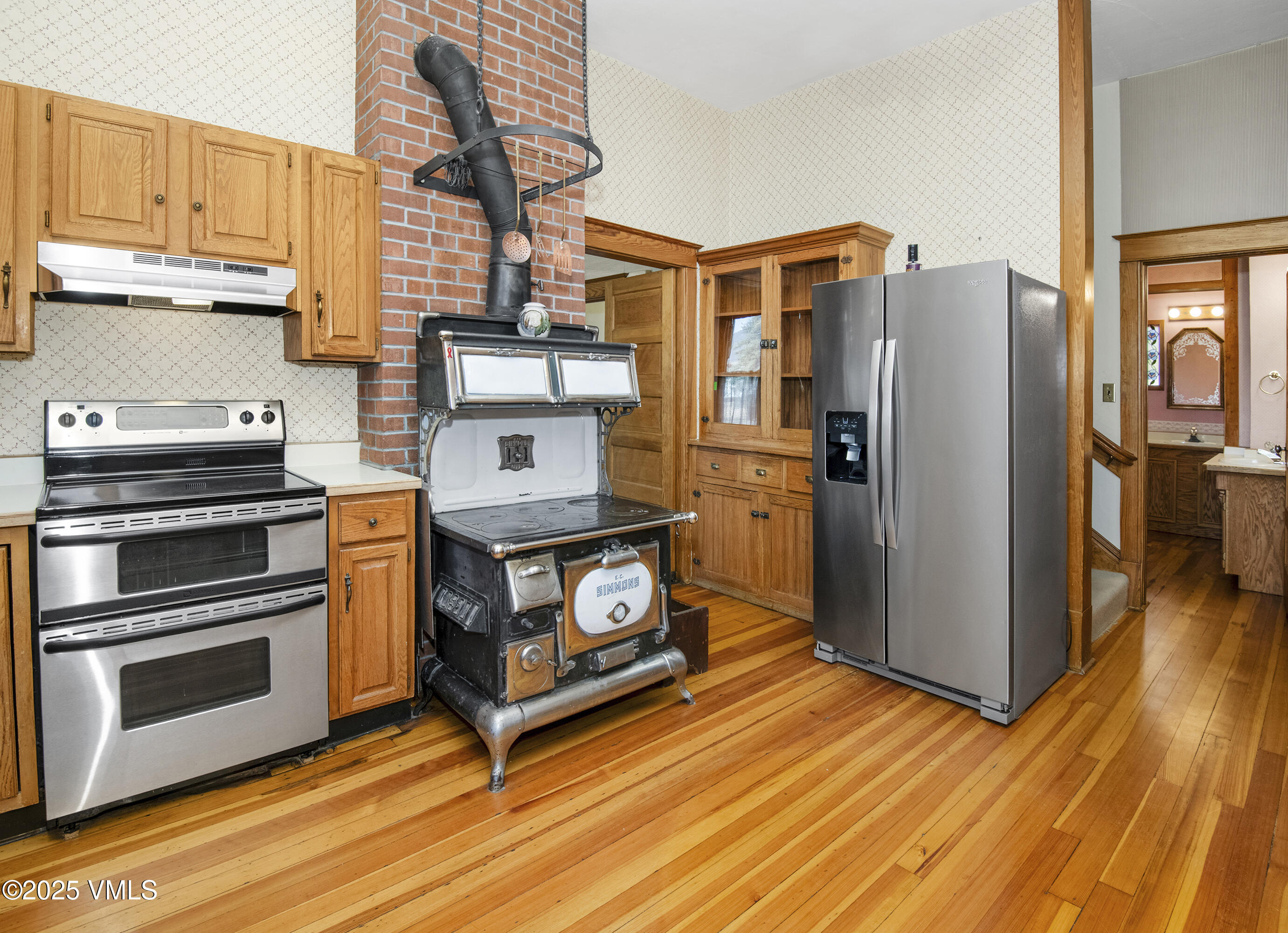 409 Washington Street Eagle, CO 81631 - Photo 10 of 28 a kitchen with appliances and wooden floor