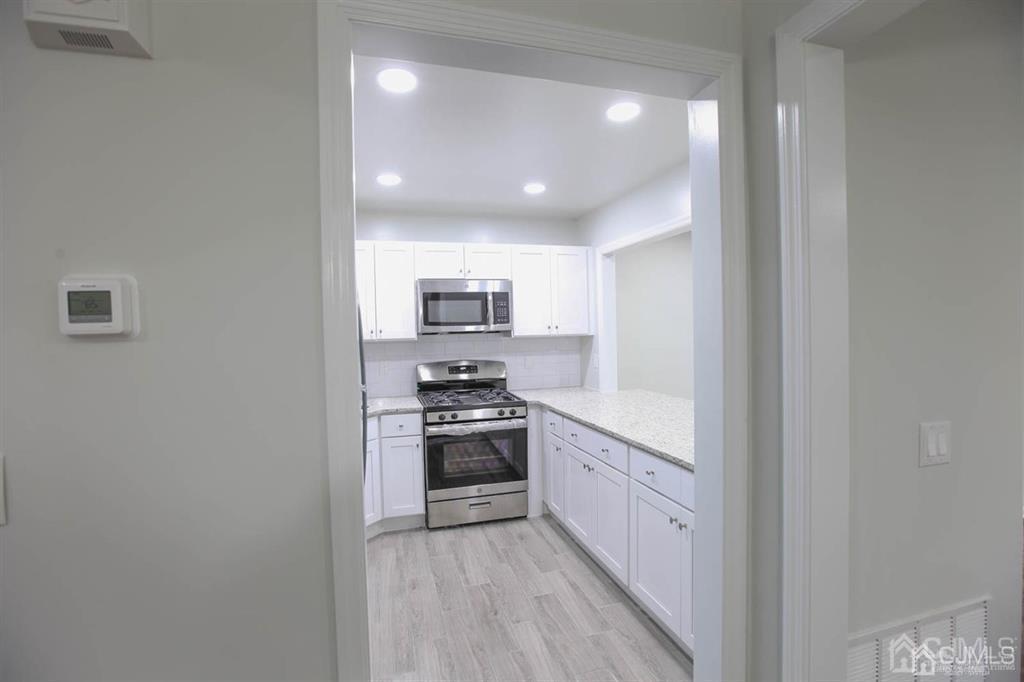 3004 Hana Road Edison, NJ 08817 - Photo 2 of 14 a kitchen with stainless steel appliances granite countertop a stove a sink and a refrigerator