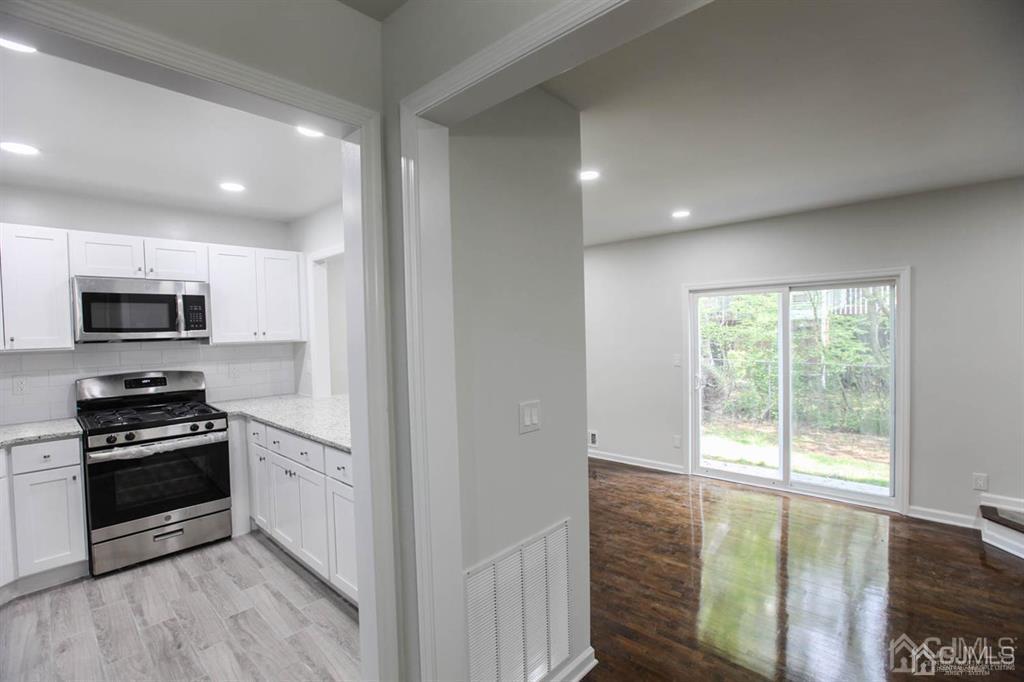 3004 Hana Road Edison, NJ 08817 - Photo 3 of 14 a kitchen with wooden cabinets and a stove