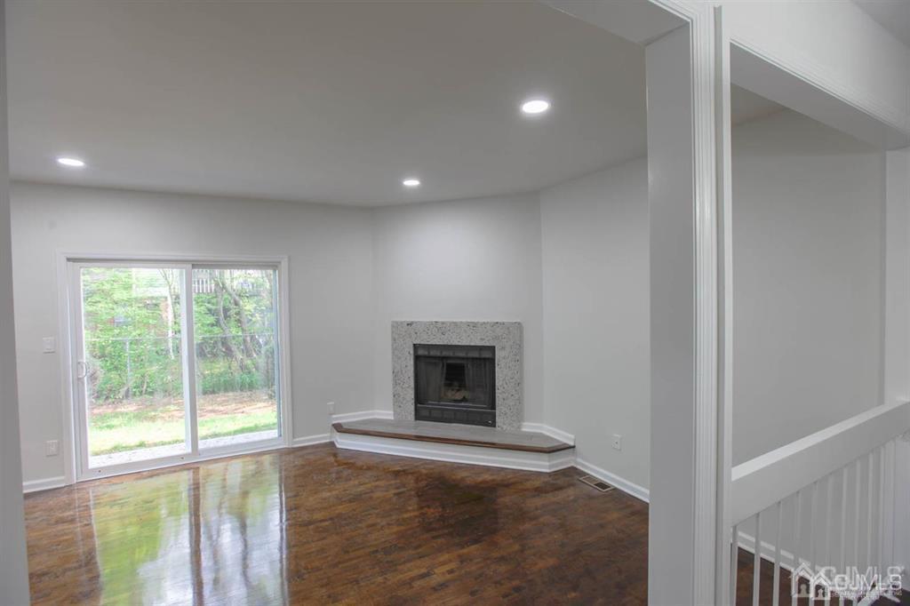 3004 Hana Road Edison, NJ 08817 - Photo 4 of 14 a view of an empty room with a fireplace and a window